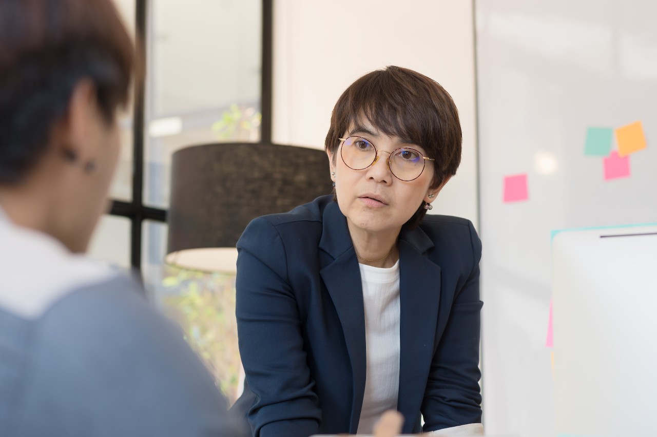Woman boss leader coaching and teaching in modern office. On the job training. Business and Education concept. Woman boss leader coaching and teaching in modern office. On the job training. Business and Education concept.