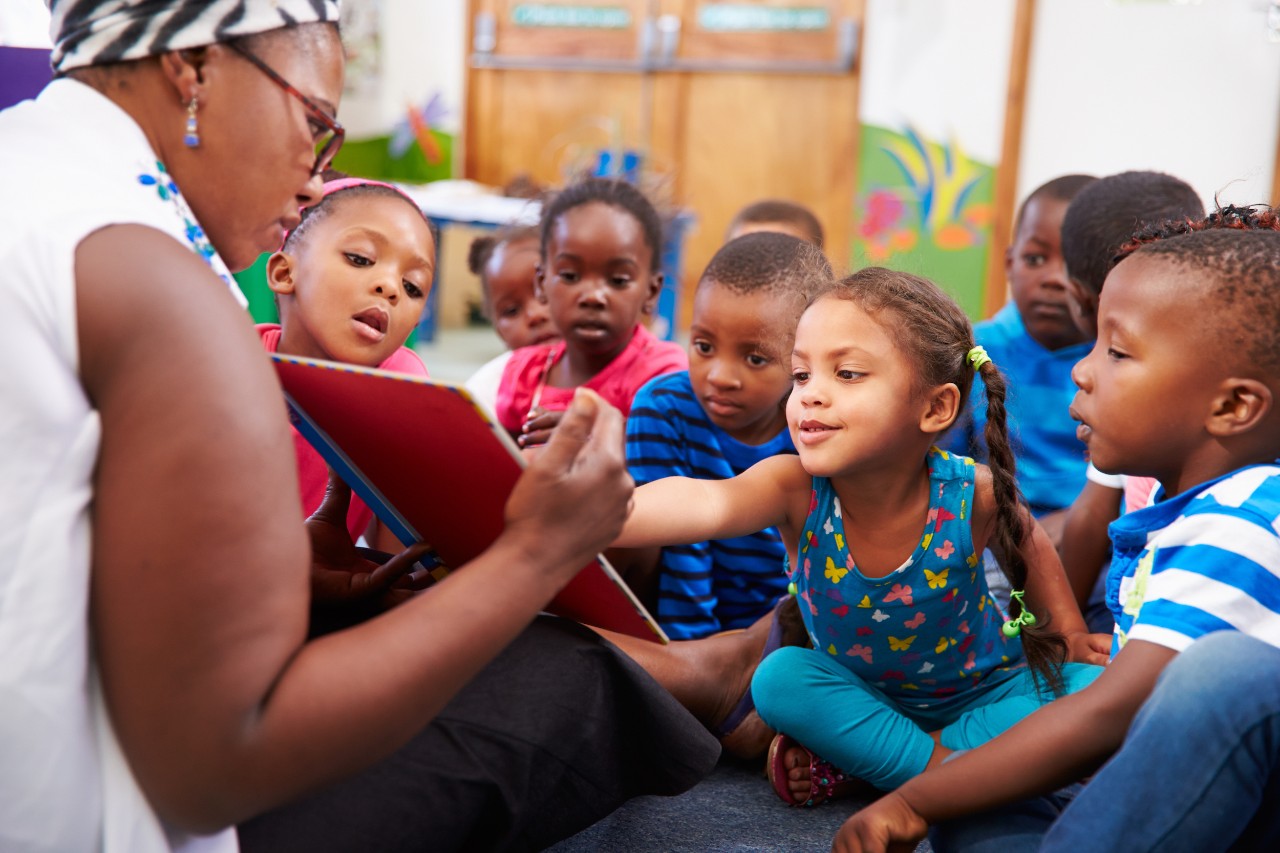 Teacher reading a book with a class of preschool children Teacher reading a book with a class of preschool children