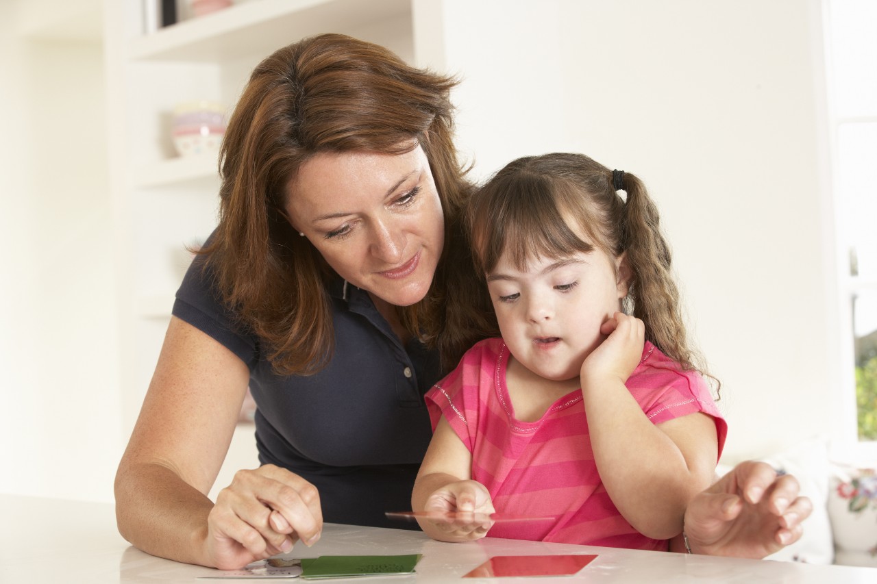 Downs Syndrome girl having speech therapy Downs Syndrome girl having speech therapy
