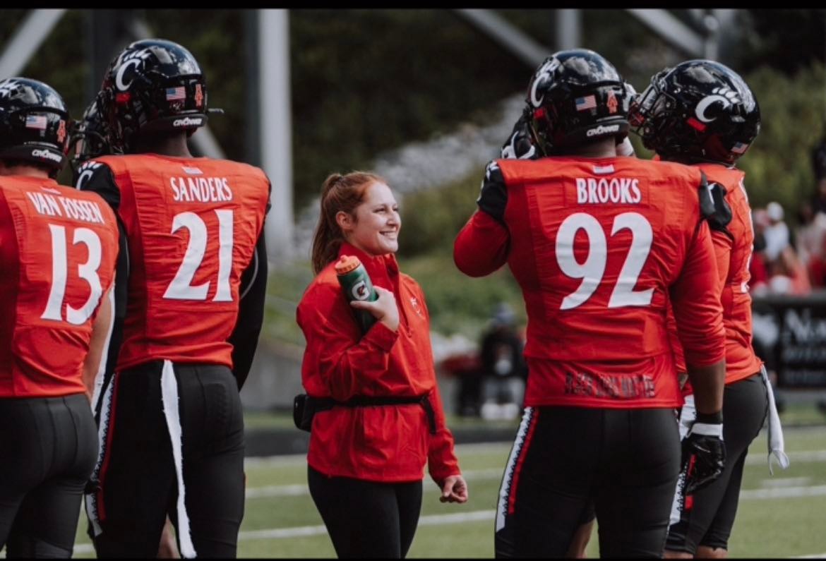 5th year student in the Accelerated Master's of Athletic Training Program, Elizabeth Morales, assists UC football players.