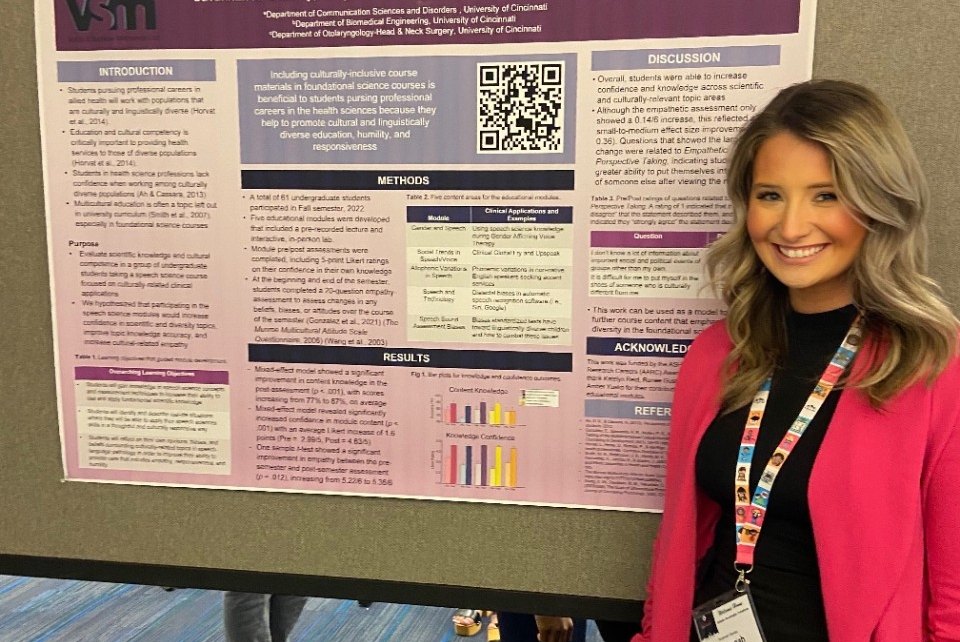 Savannah Shanley, 1st year Speech-Language Pathology student, stands in front of her poster presentation.