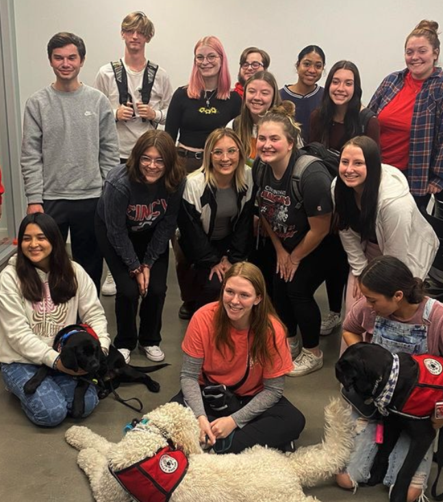 Students pet Sammy, the service dog